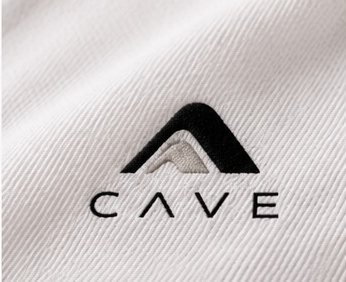 Embroidered CAVE mark on white piqué